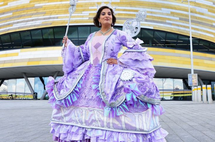 Mina Anwar dressed at the Fairy God Mother holds her wand aloft